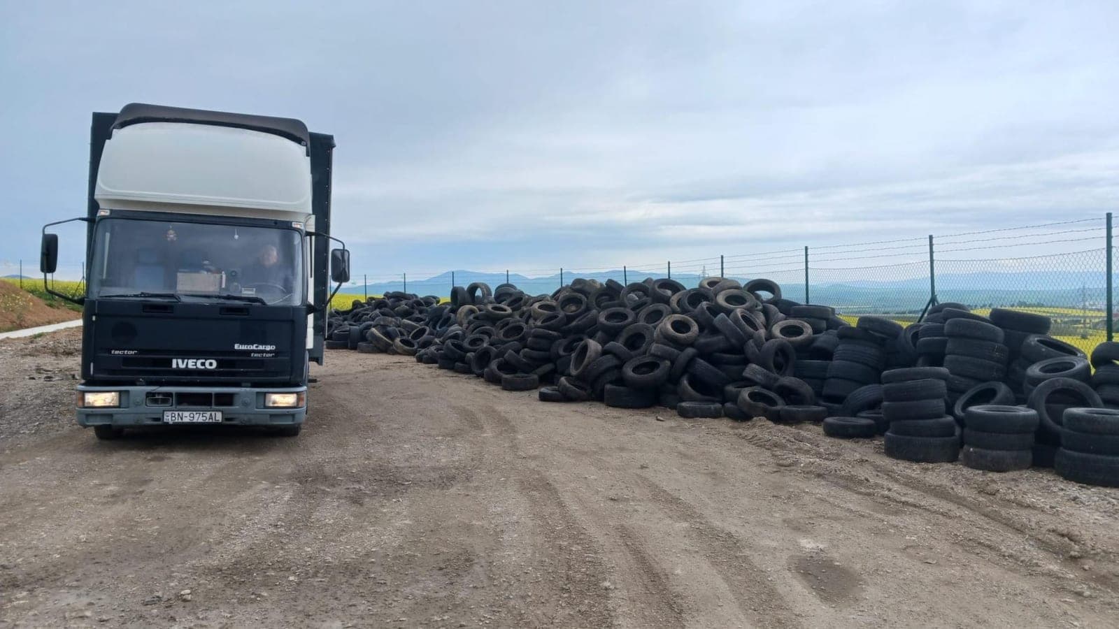 Lorry beside a pile of old tyres
